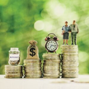 Senior couple, clock, money bag, saving jar on steps of rising coins