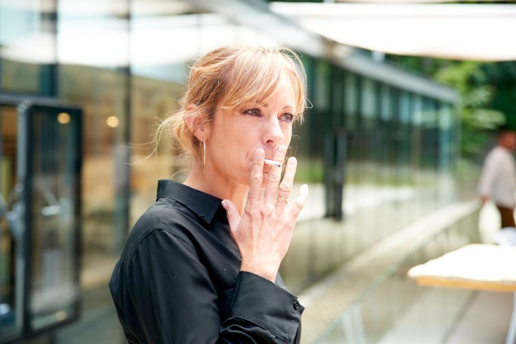 A woman smoking a cigarette.