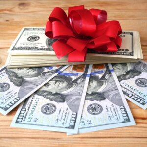 stack of money with a red bow