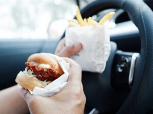 Eating while driving can cause drivers to crash.