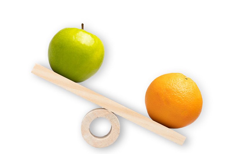 Comparison of apple and oranges. Conceptual shot around comparison, differentiation, choice and selection.