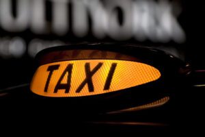 orange taxi light lit up at night.