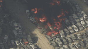Several hundred crushed cars burn in a massive junkyard fire near L.A.