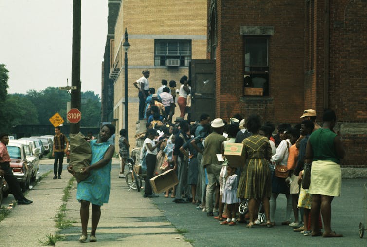 People line up in front of a building.
